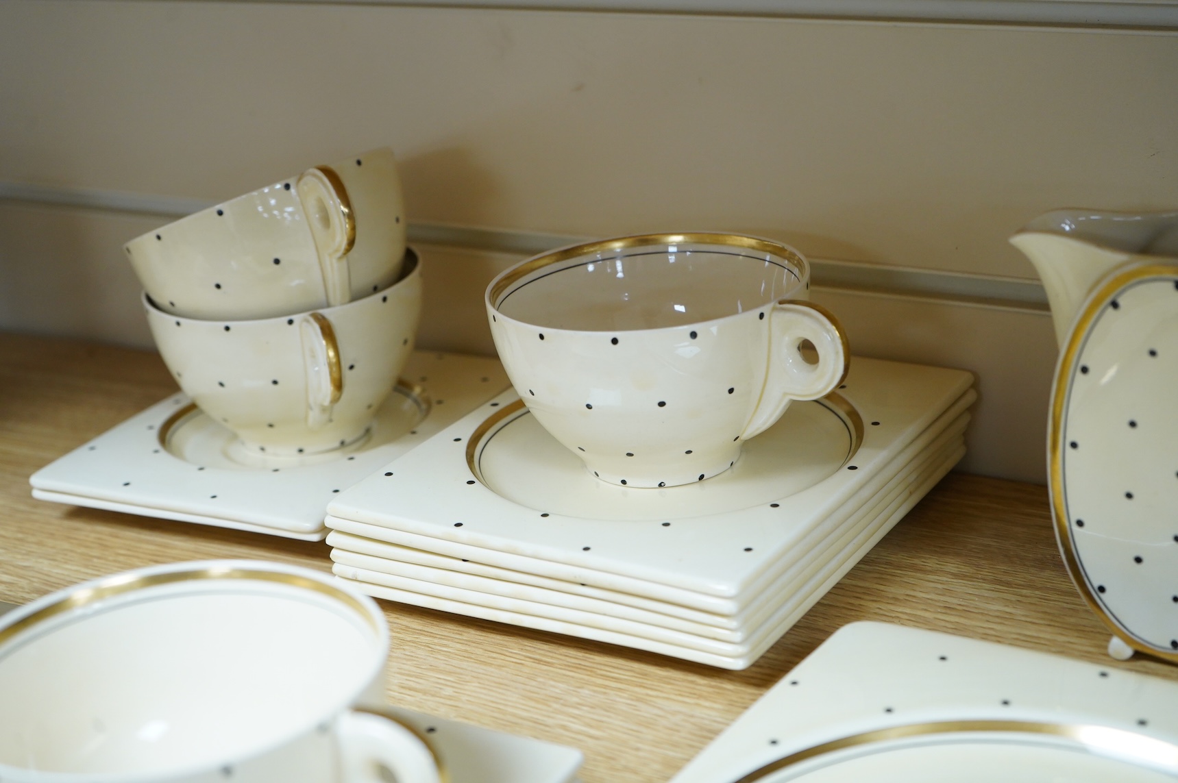 A Clarice Cliff Biarritz-shape 21-piece part teaset including trencher plates and saucers, impressed date-code 1935, jug 13cm